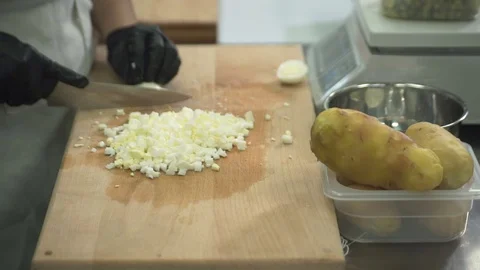 Chef cuts eggs on chopping board in kitchen at restaurant Stock Footage 71527702