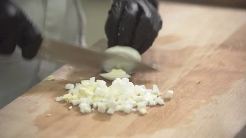 Chef cuts eggs on chopping board with knife in kitchen at restaurant Video stock 72091289