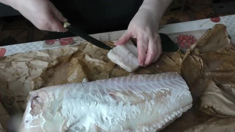 The chef cuts fresh cod fish into pieces Stock Footage 173561355