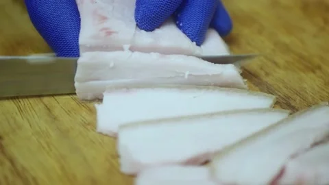 The chef cuts fresh lard on a cutting board 스톡 동영상 221702263