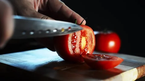 Chef cuts fresh red tomato for salad and pizza Stock Footage