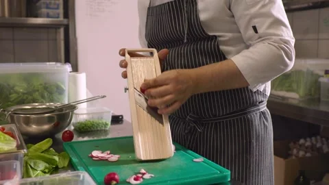 A chef cuts fresh vegetables in a spacious modern kitchen in a restaurant. Stock Footage 277133182