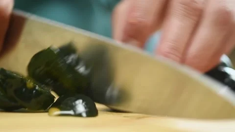 The chef cuts green figs with a knife. Stock Footage 202072411