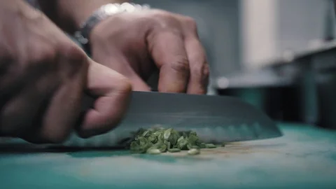 Chef cuts green onions with a sharp knife Stock Footage 112590026