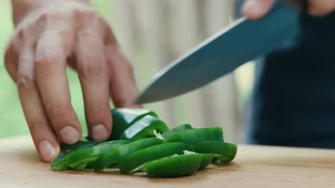 Chef cuts green pepper close up of hand and knife full HD video Stock Footage 130770585