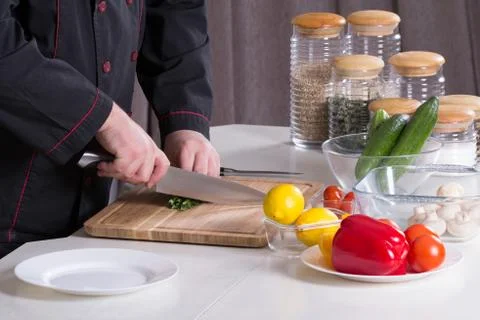 The chef cuts the greens Stock Photos