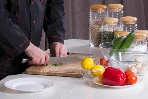 The chef cuts the greens Stock Photos