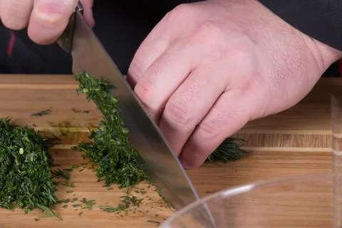 The chef cuts the greens Stock Photos