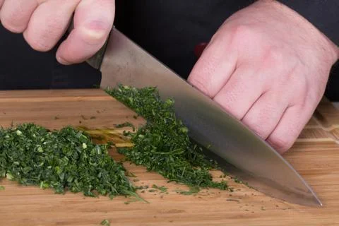 The chef cuts the greens Stock Photos
