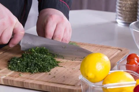 The chef cuts the greens Stock Photos