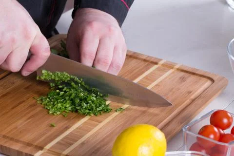 The chef cuts the greens Stock Photos