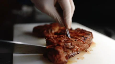 Chef cuts juicy steak. Stock Footage 145855735