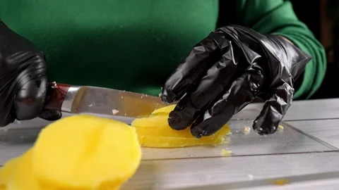 The chef cuts large potatoes for the olivier salad. Stock Footage 291685037