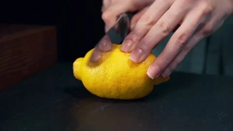 Chef cuts lemon in a half fruit salad Stock Footage 143777053