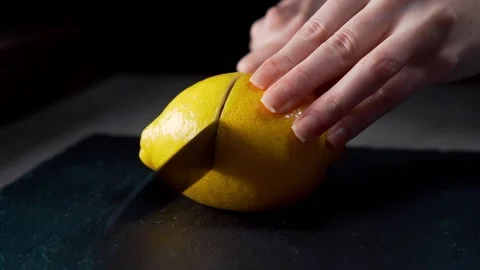 Chef cuts lemon in a half fruit salad Stock Footage 143777054