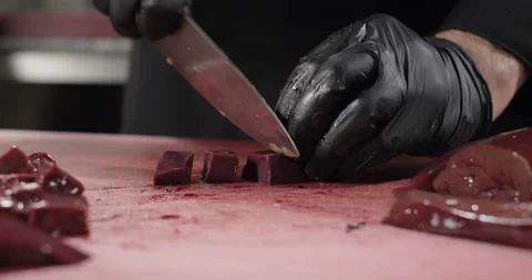 Chef cuts liver on a cutting board. Oriental cuisine. Close-up Stock Footage 273380745