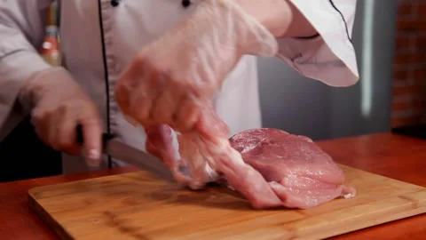Chef cuts meat on a cutting board Video stock 87049234