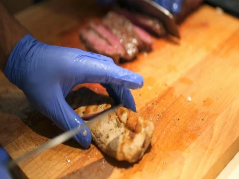 Chef cuts meat for a salad Stock Footage 81310697