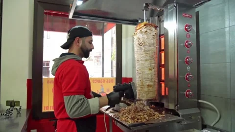 Chef cuts meat for shawarma Stock Footage 188463046