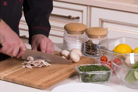 The chef cuts the mushrooms Stock Photos