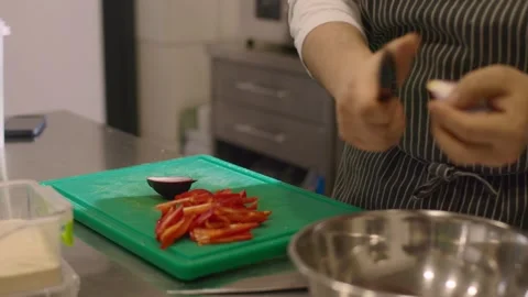 A chef cuts an onion in a restaurant kitchen. Stock Footage 277131563