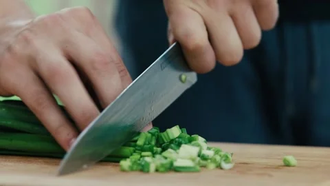 The chef cuts onions with a knife close-up Stock Footage 130992402