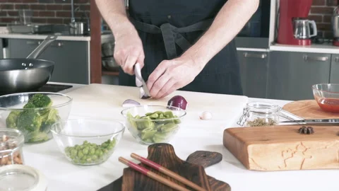 Chef Cuts Onions In Restaurant Kitchen On Cutting Board. Cooking Food. Stock-Footage 142807294