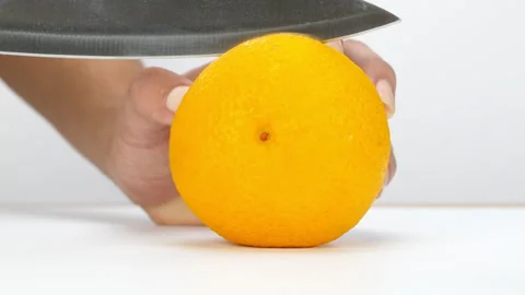 Chef cuts an orange in half. Stock Footage 220818478
