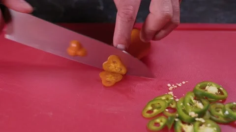 Chef cuts orange pepper. Stock Footage 164254381