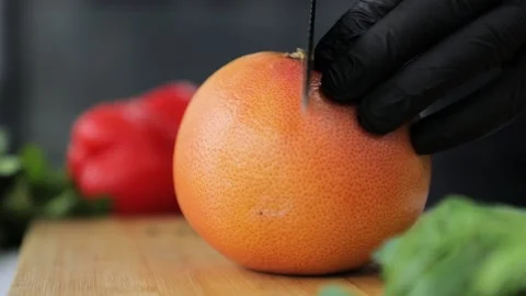 Chef cuts the orange in two Video stock 160497170