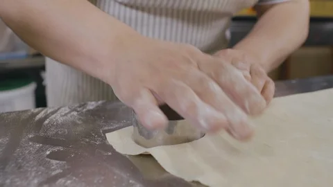 Chef cuts out dough circles for baking cookies or dumplings Stock Footage 125051534