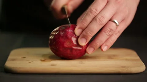 Chef cuts a passion fruit to extract juice and seeds Stock Footage 60252769