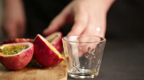 Chef cuts a passion fruit to extract juice and seeds Video stock 60252770