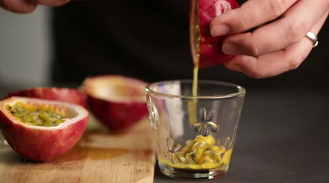 Chef cuts a passion fruit to extract juice and seeds Stock Footage 60252779
