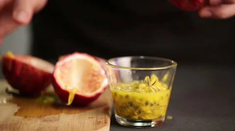 Chef cuts a passion fruit to extract juice and seeds Stock Footage 60252806