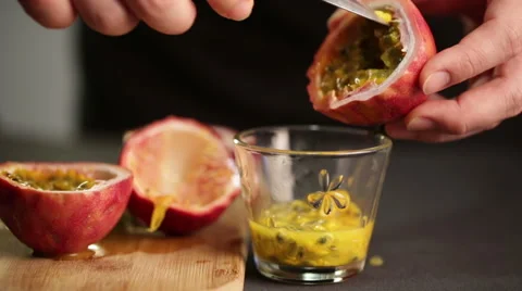 Chef cuts a passion fruit to extract juice and seeds Stock Footage 60252813