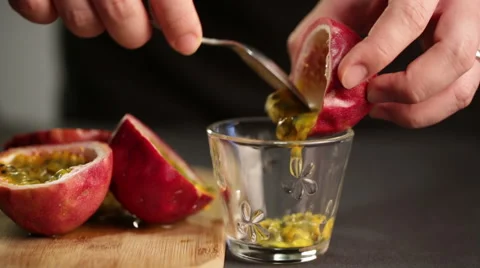 Chef cuts a passion fruit to extract juice and seeds Stock Footage 60252832