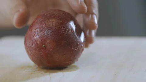 Chef cuts a passion fruit to extract juice and seeds. Stock Footage 92015979