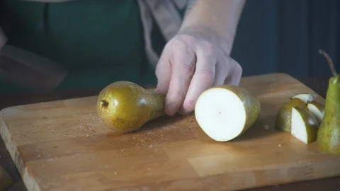 Chef cuts pear fruit on a cutting board in a restaurant. Food on cuisine. Stock-Footage 124751746