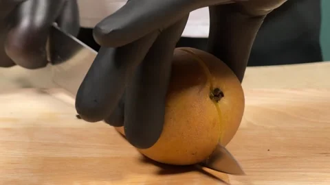 A chef cuts a pear for his dish Stock Footage 306803747
