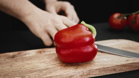 The chef cuts the pepper with a knife on a chopping board Stock Footage 208819728