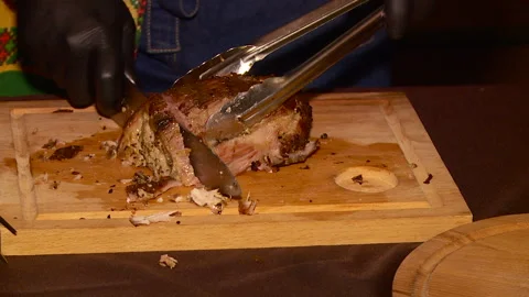 Chef cuts a piece of meat Stock Footage 103569798