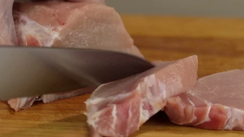 Chef cuts a piece of raw pork carbonate Stock Footage 122107012