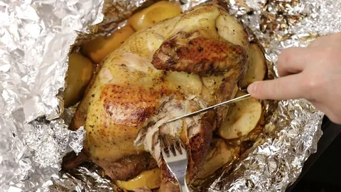 Chef cuts into pieces the fried or roasted chicken just cooked Stock Footage 121330736