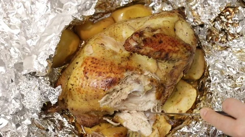 Chef cuts into pieces the fried or roasted chicken just cooked. Stock Footage 121330943
