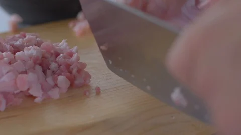Chef cuts pieces of raw bacon by sharp knife on the wooden board Stock Footage 111271539