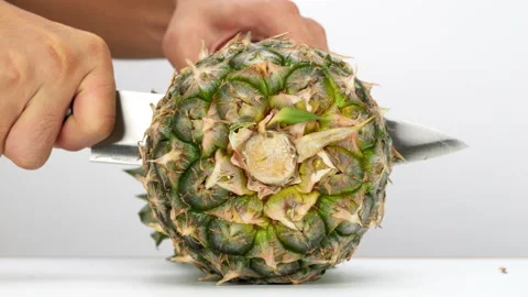 Chef cuts pineapple in half. Stock Footage 220818408