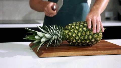 Chef cuts the pineapple slow motion Stock Footage 169756639
