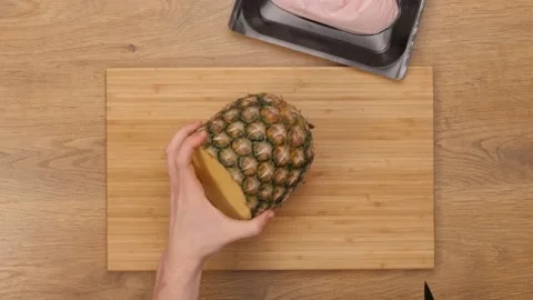 Chef cuts the pineapple. top plan  Video stock 164153079