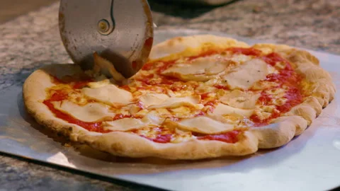 The chef cuts the pizza with pork and cheese. Food before serving. Stock Footage 159338995